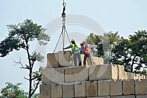 Construction workers stacking the maintain load test block at the construction site